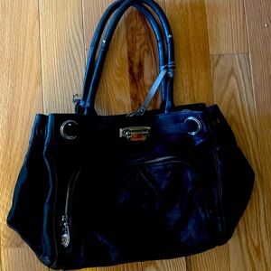 Black leather bag. With small tear in back.